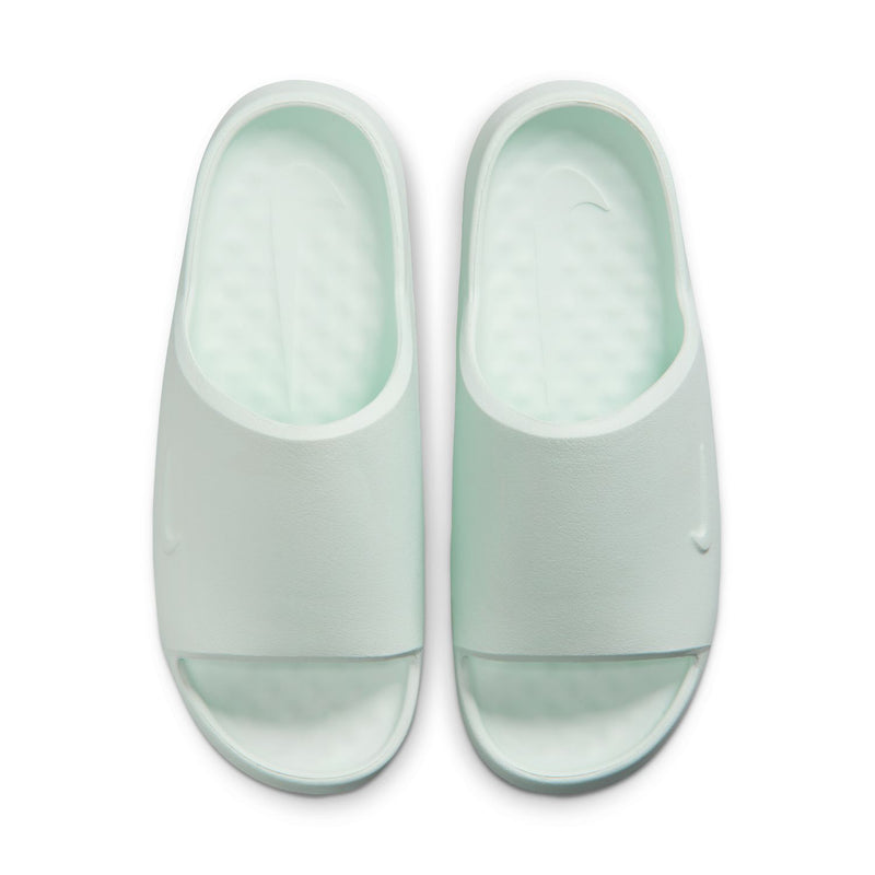 Pair of mint slide sandals with rounded open toe and curved heel