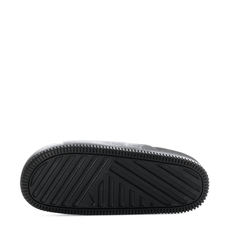 Black slide sandal outsole pattern and ridged tread, close bottom view