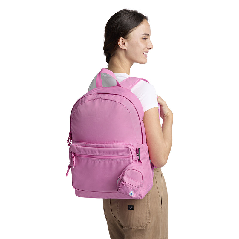 Oops Pink mini backpack worn on back, front zip pocket and side pouch visible