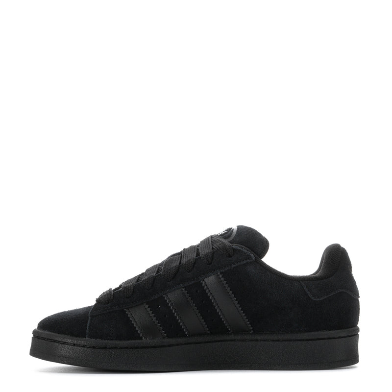 Black suede low-top sneakers, side view with three stripe panels and black laces