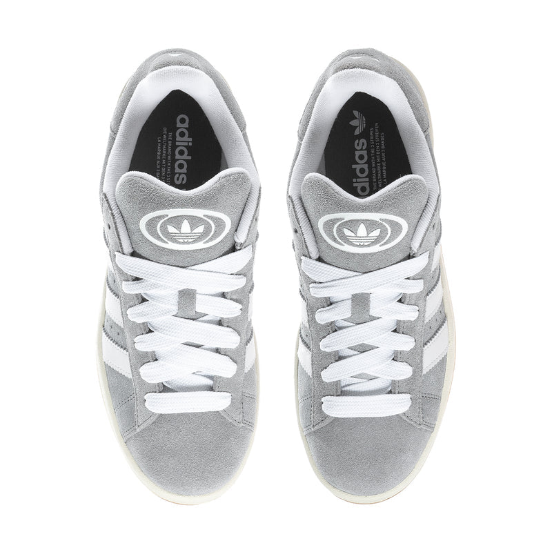 Men's grey low-top sneakers with white laces and adidas logo on tongue