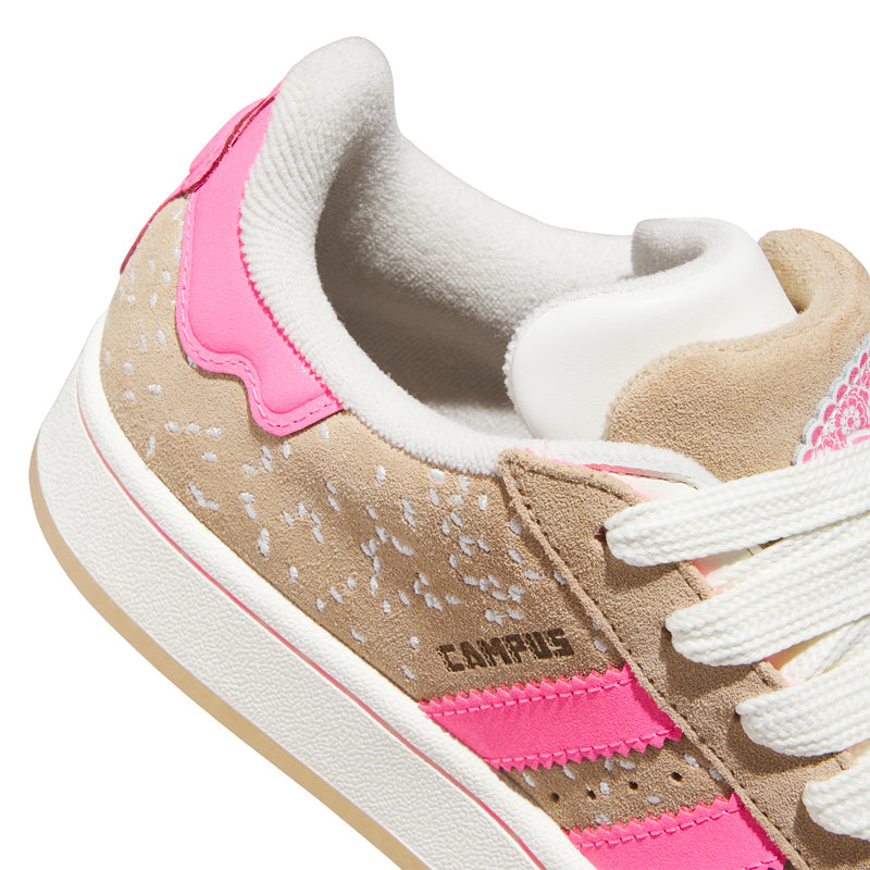 Women's sneakers collar close-up, white lining with tan and pink overlays, white laces