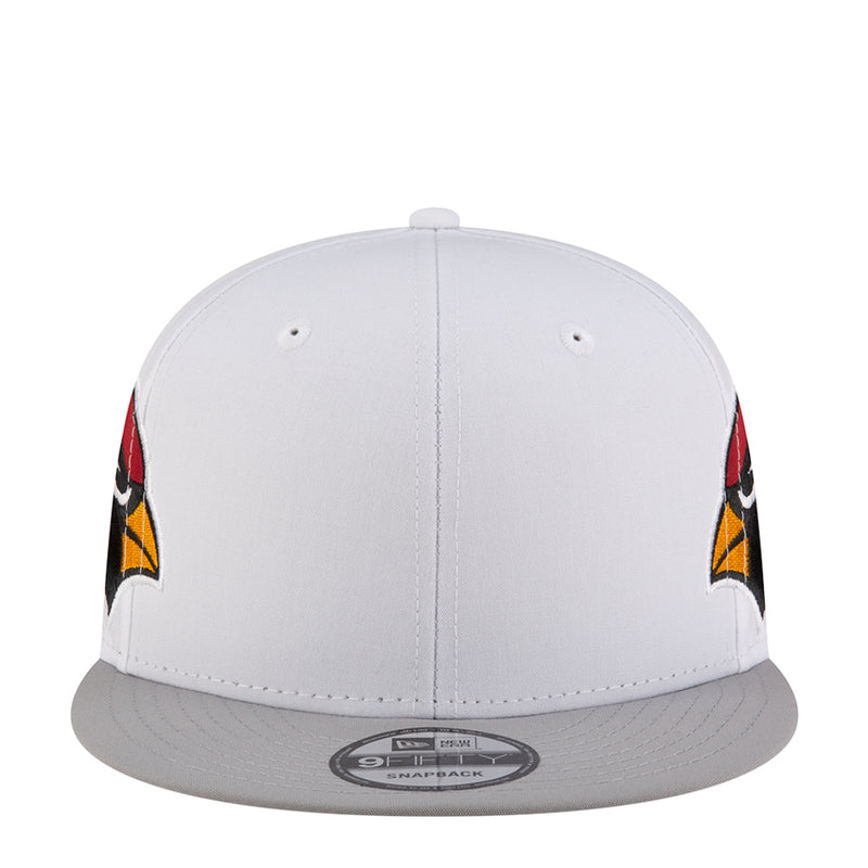 White snapback cap with gray brim and side logo accents in red and yellow