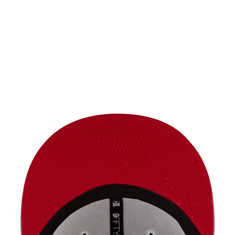 Red cap fabric panel with black trim, close-up texture