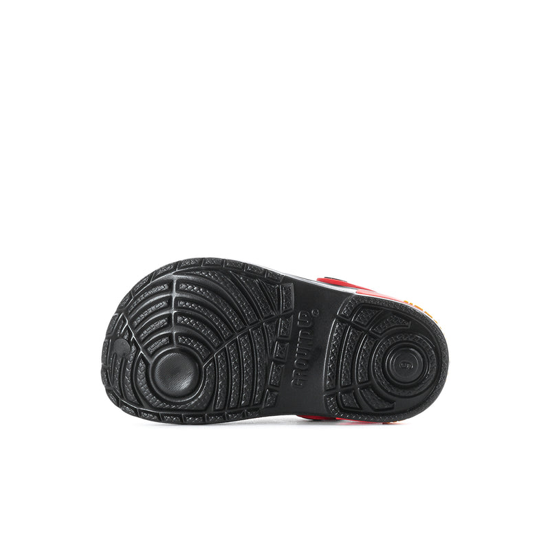 Treaded outsole of black and red toddler EVA clog with circular traction pattern