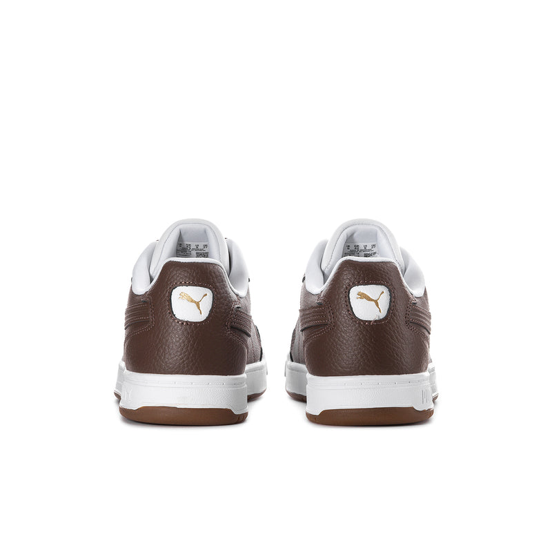 Brown and white sneakers from back with Puma emblem on the heel