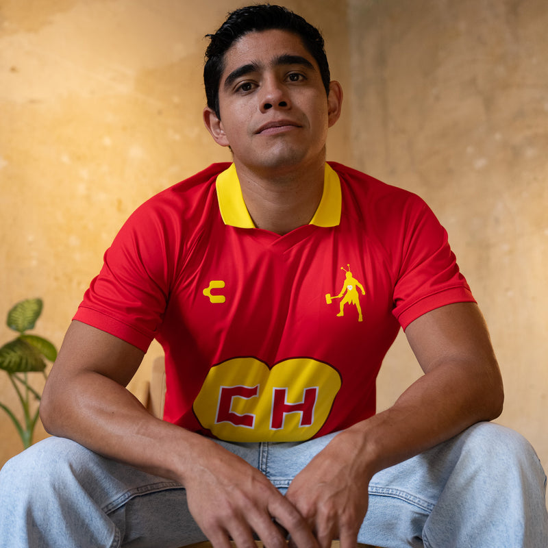 Red men's sports jersey with yellow collar, EH heart logo and polo player emblem