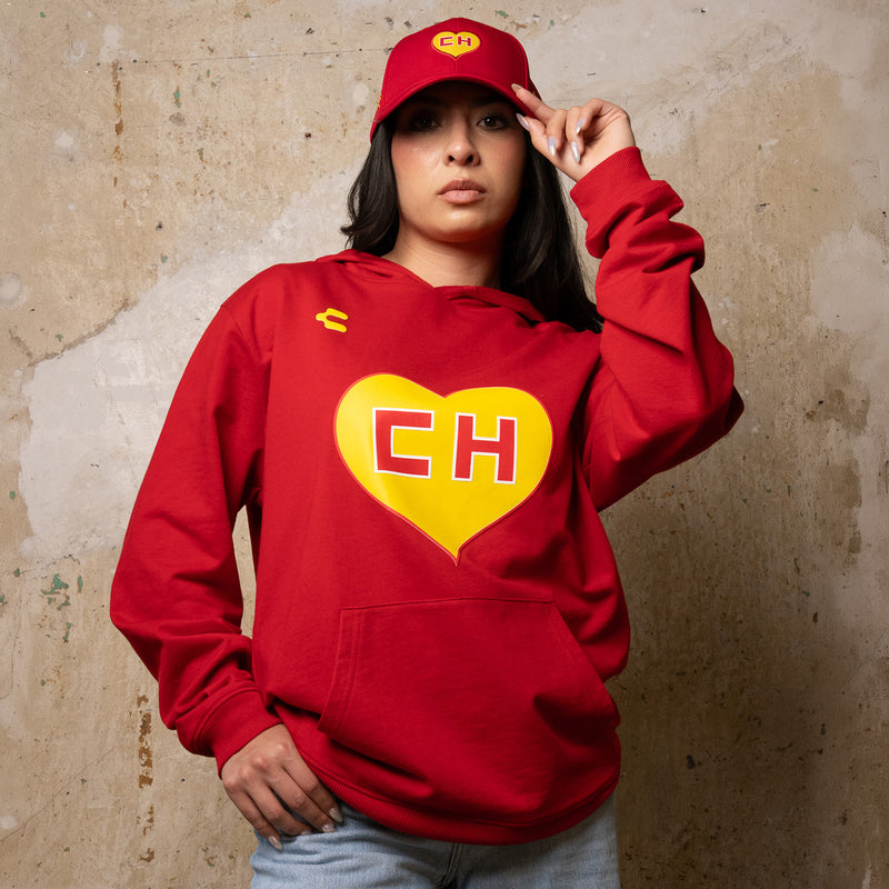 Red pullover hoodie on model with yellow CH heart graphic centered on back