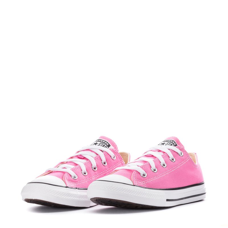Pair of pink kids low-top canvas sneakers with white laces and rubber soles.