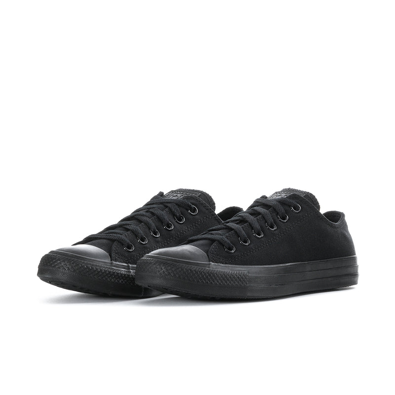 Pair of black low-top lace-up canvas sneakers with rubber toe caps and textured sole