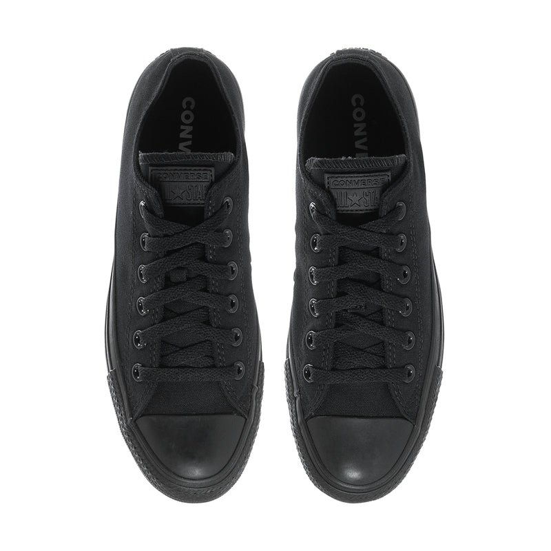 Black low-top lace-up canvas sneakers, interior view of tongue and laces