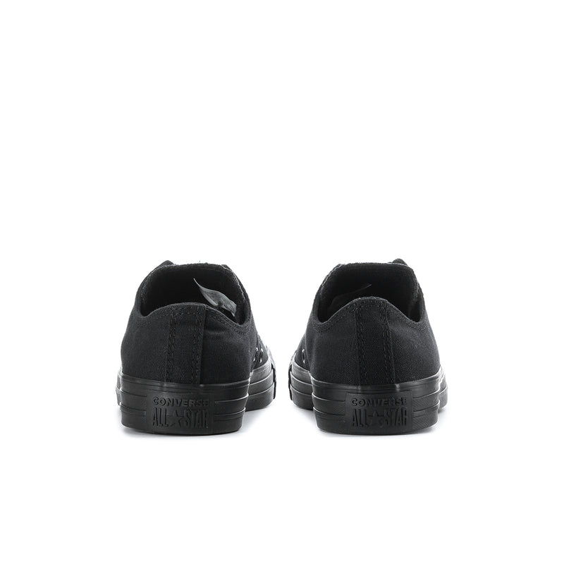Black low-top lace-up canvas sneakers, rear view with heel branding and rubber sole
