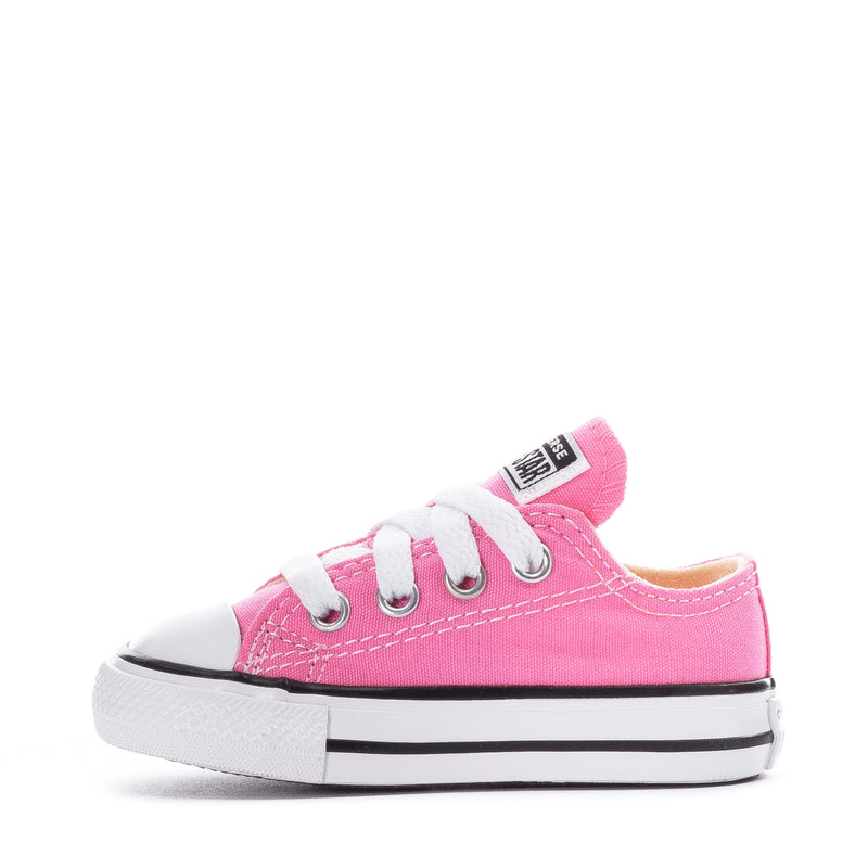 Toddler pink Chuck Taylor low-top sneaker, side view with eyelet lacing