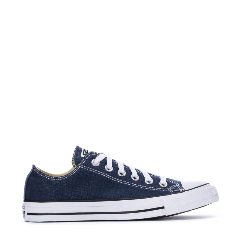 Youth navy canvas ox sneaker side view with white laces and striped rubber sole