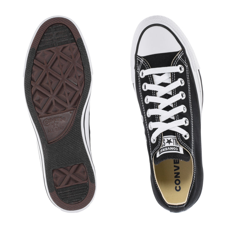 Youth black low-top sneaker outsole and interior label with white laces