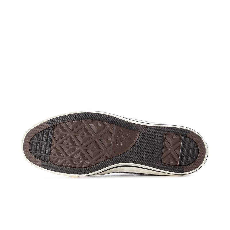 Low-top sneaker outsole with textured tread, dark rubber edge, and light midsole