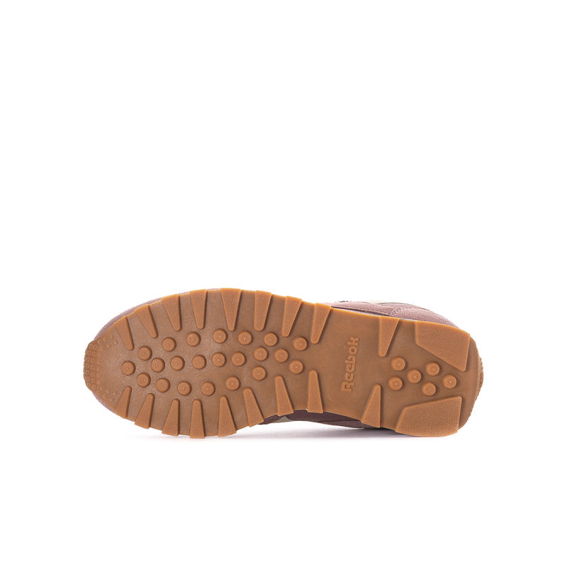 Youth sneaker outsole with brown traction tread and Reebok branding