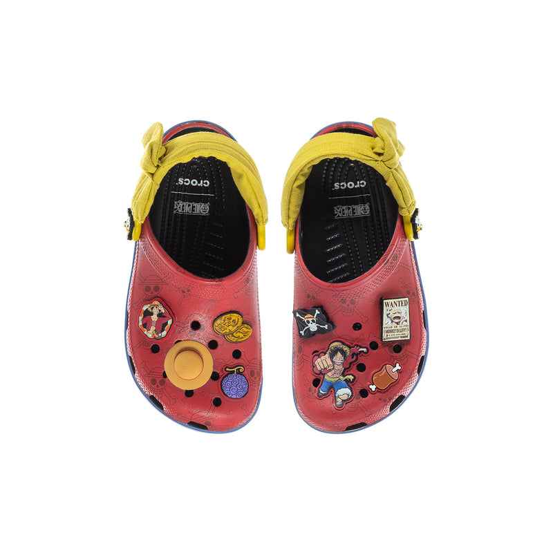 Kids red clog tops with yellow strap, cartoon patches, and printed interior label