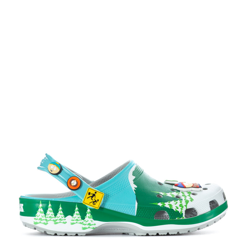 Men's clog in green and turquoise with playful graphic accents and strap.