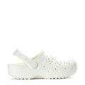 Women's clogs in white with floral cutout uppers and adjustable strap
