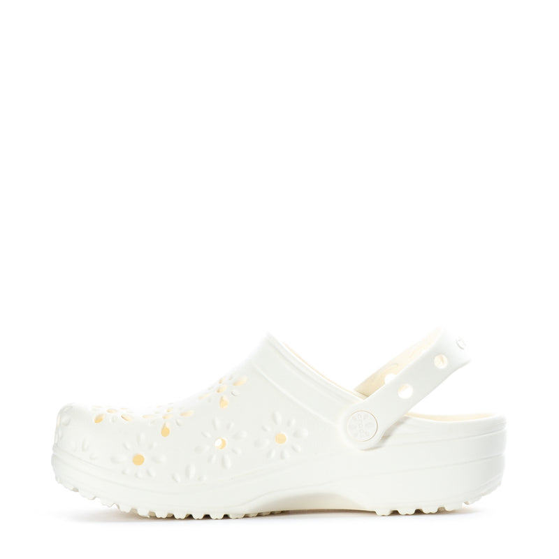 Women's white clog with daisy cutouts across the side and strap detail