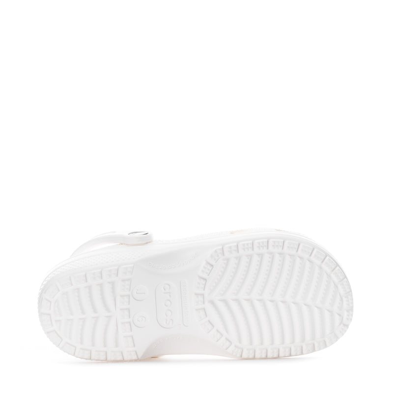 Youth white clog outsole view with textured tread and molded traction pattern.