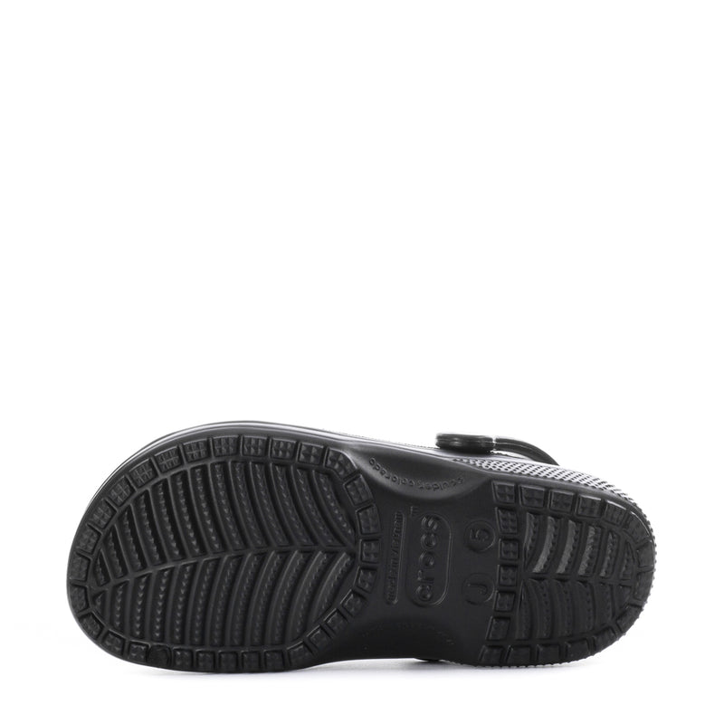 Youth black clog outsole view with deep tread and molded traction patterns.