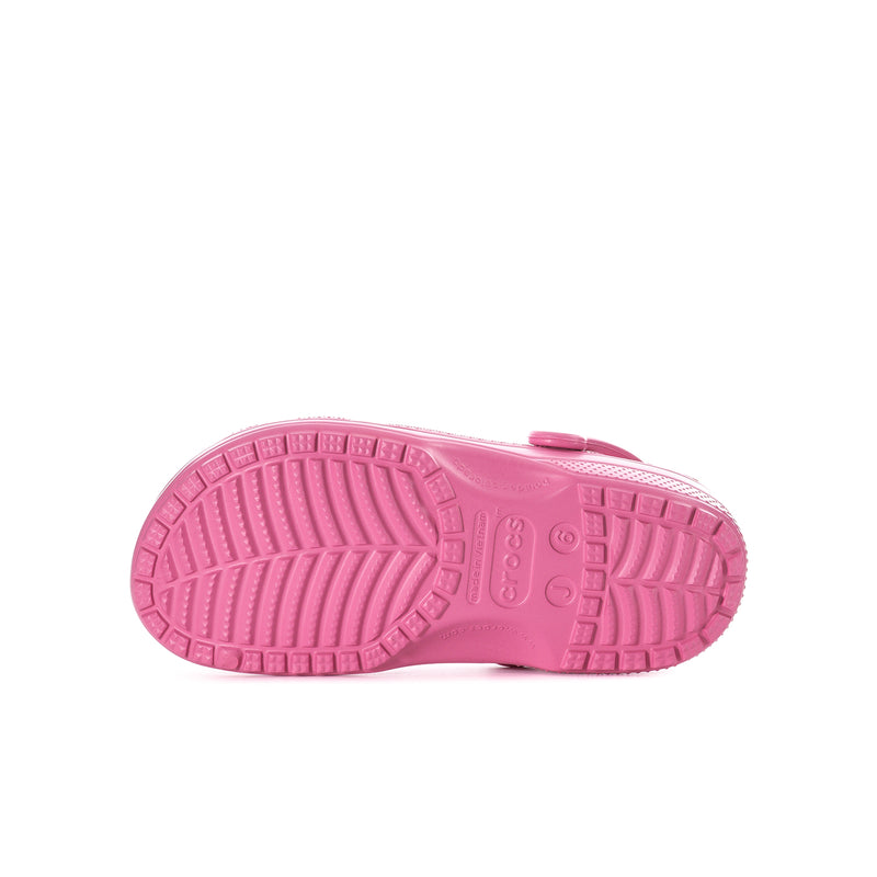 Youth pink clog outsole view with patterned grip tread and brand detailing