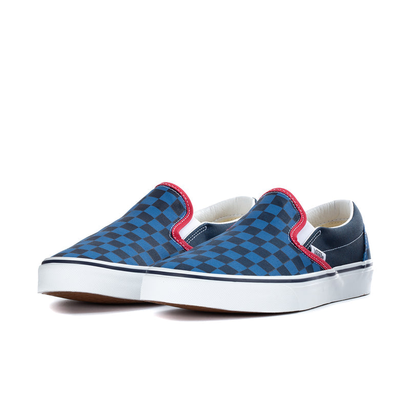 Men's slip-on sneakers with blue checkerboard uppers, red edging, white sole.