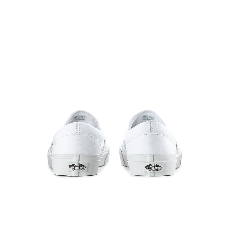 White slip-on sneakers, rear view with VANS logo on heel tab and treaded sole