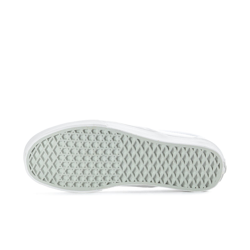 White rubber outsole of mens slip-on sneakers with grippy tread pattern