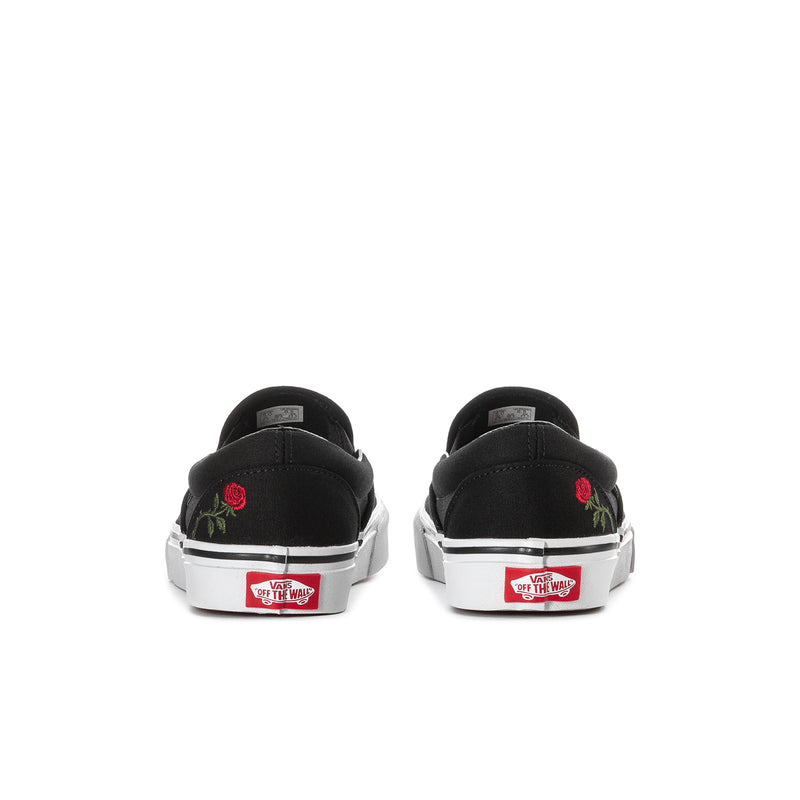 Black VANS slip-on sneakers, heel view, with red rose embroidery and label patch
