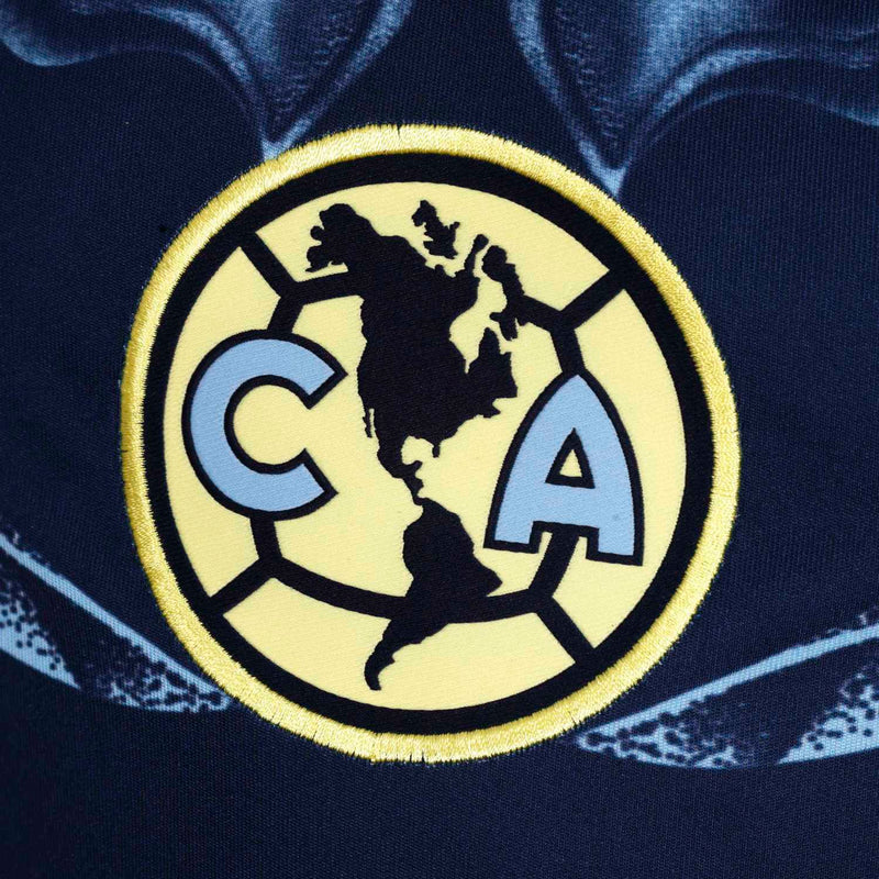 Youth Club America crest badge on navy jersey with gold and light-blue details
