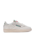 White low-top leather sneakers with Reebok logo and green tongue patch
