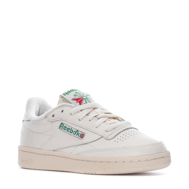 White low-top sneakers with lace-up front, Reebok logo, beige sole