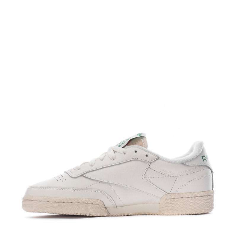 White low-top sneakers with side panel stitching and beige rubber sole
