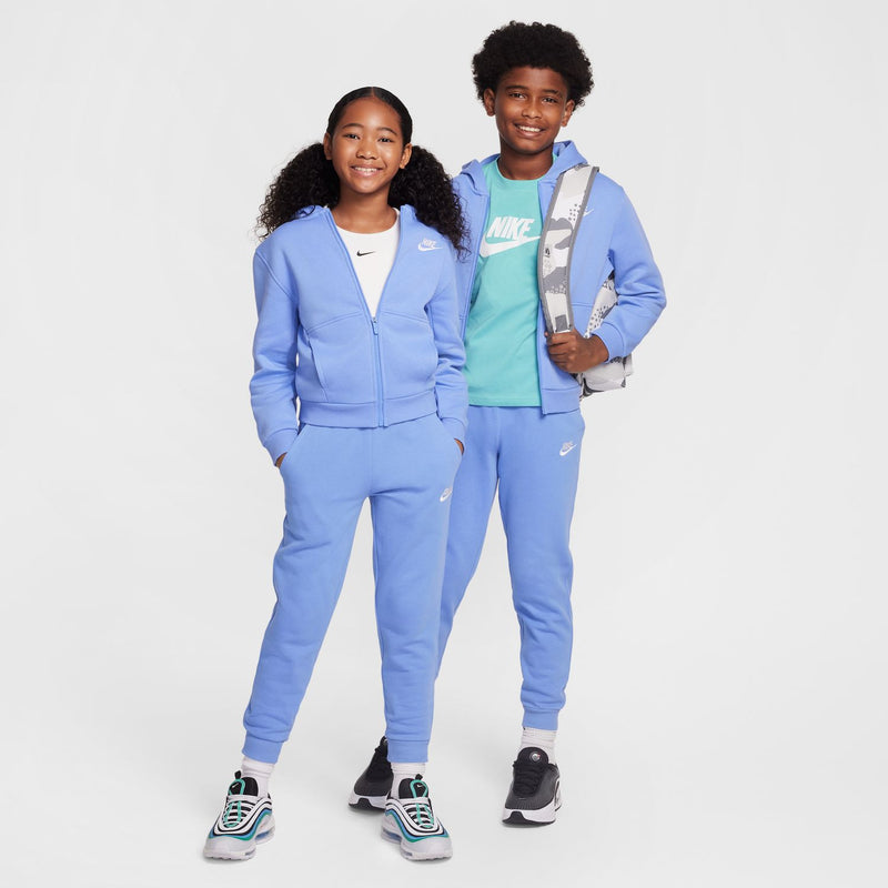 Light blue youth fleece jogger pants worn with sneakers, Nike swoosh