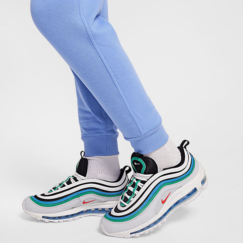Light blue youth fleece jogger pants with ribbed ankle cuffs and sneakers
