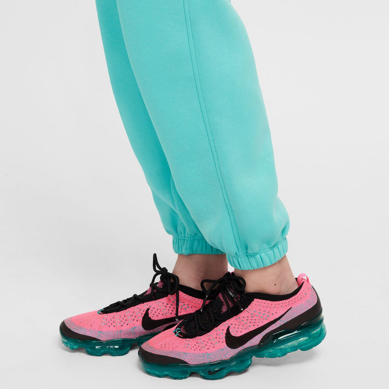 Youth teal/turquoise jogger pants with cuffed ankles and athletic sneakers