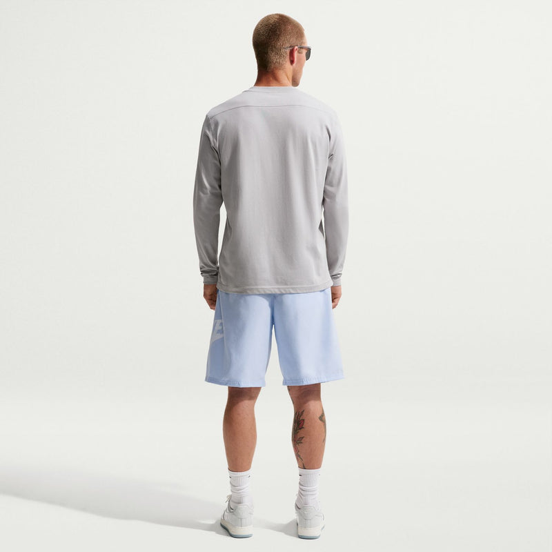 Men's light blue swim shorts, back view with elastic waistband and logo