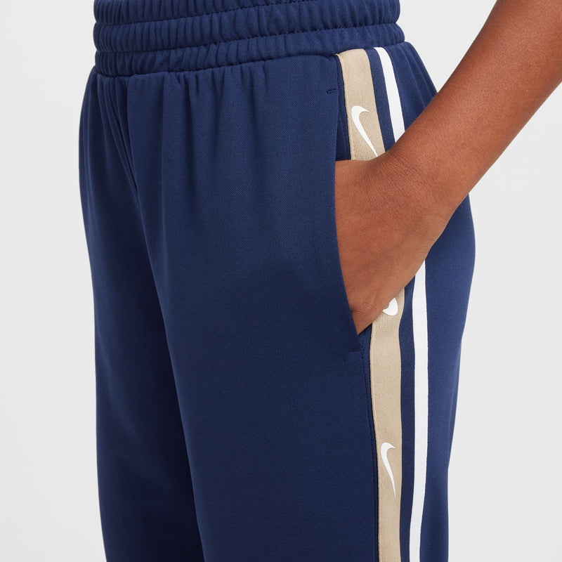 Close-up of youth navy joggers waistband with adjustable drawcord and stripe seam detail.