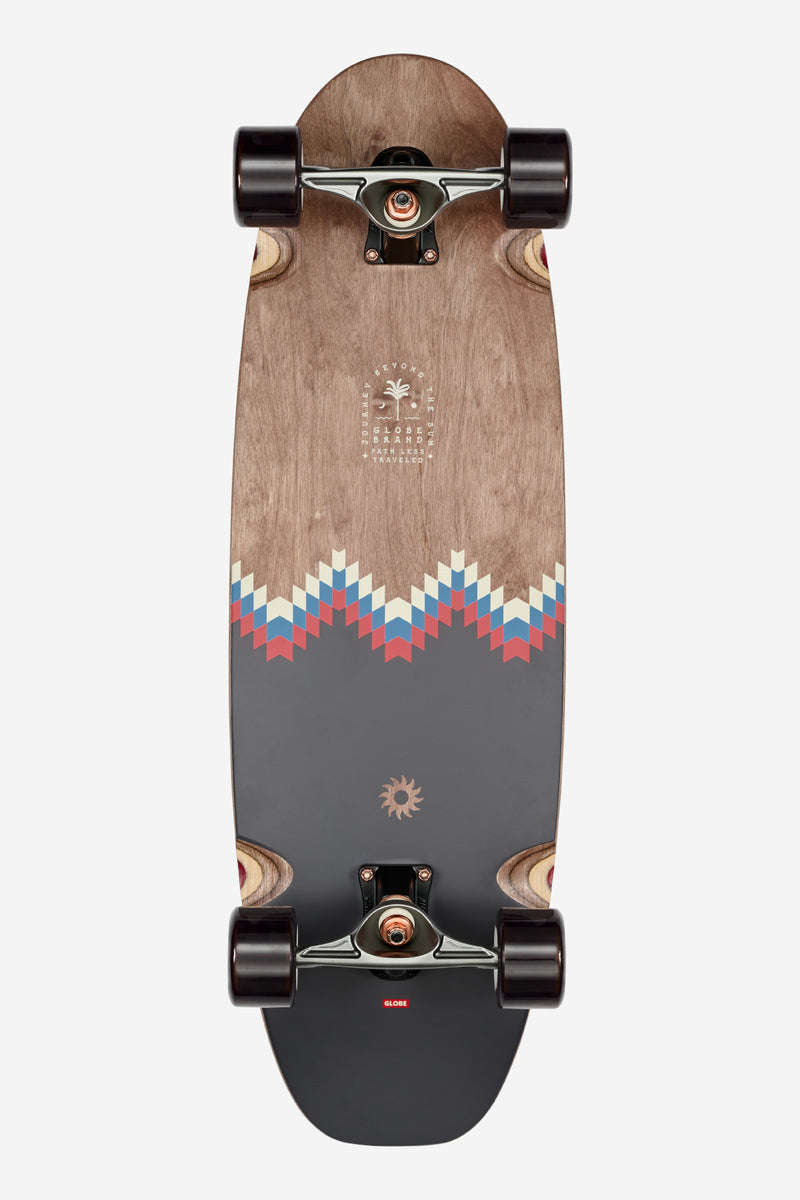 Top view of Mirage cruiserboard showing natural wood deck with center inlay stripe and large dark wheels