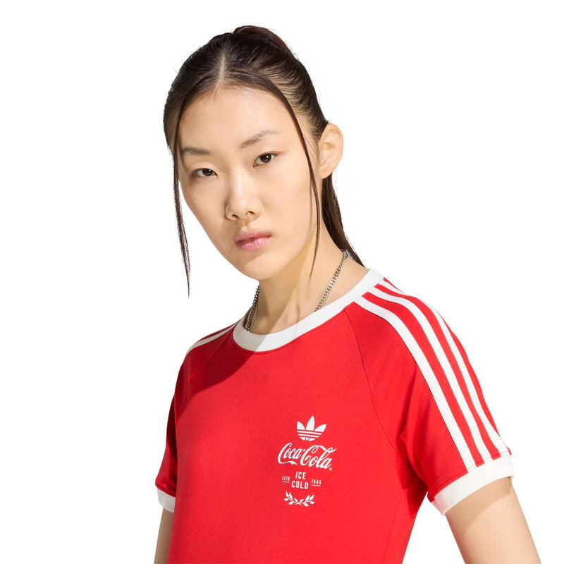 Red women's graphic tee close-up with white adidas shoulder stripes and Coca-Cola logo