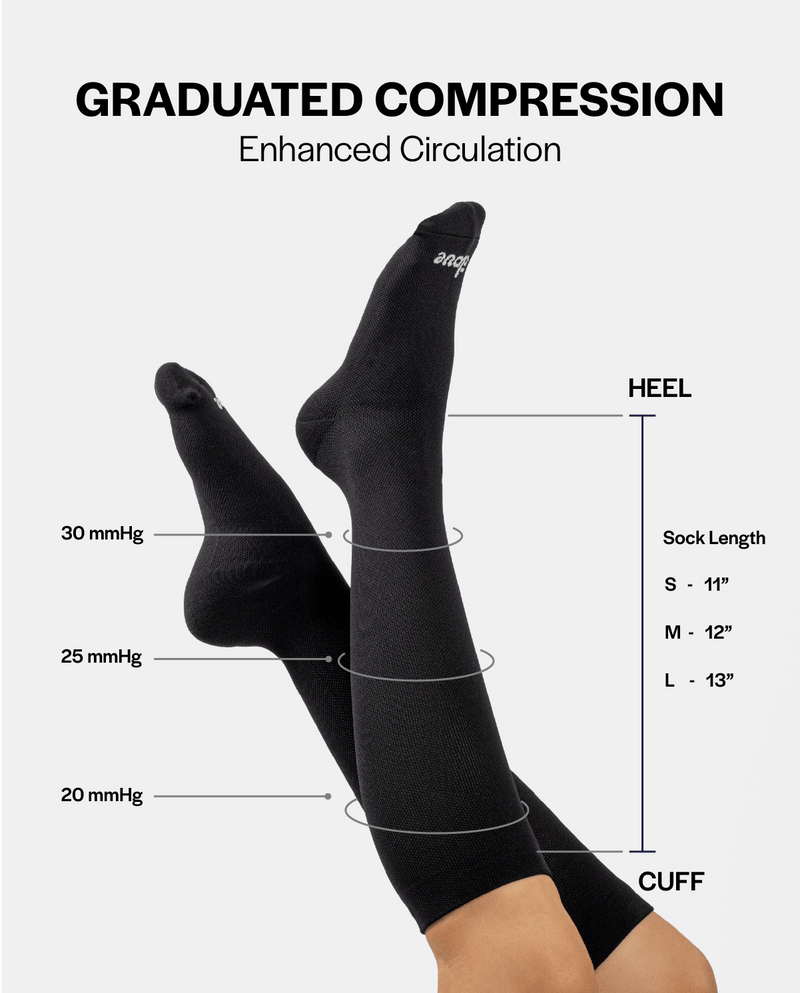 Black compression socks with labeled measurements on a white background