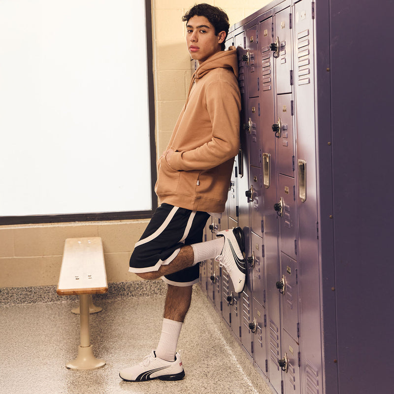 Men's contrast tape shorts shown from the side with white hem tape detail
