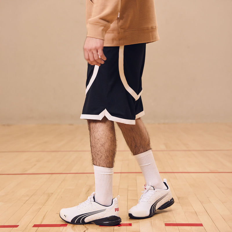 Men's contrast tape shorts close-up: dark shorts with white side and bottom tape