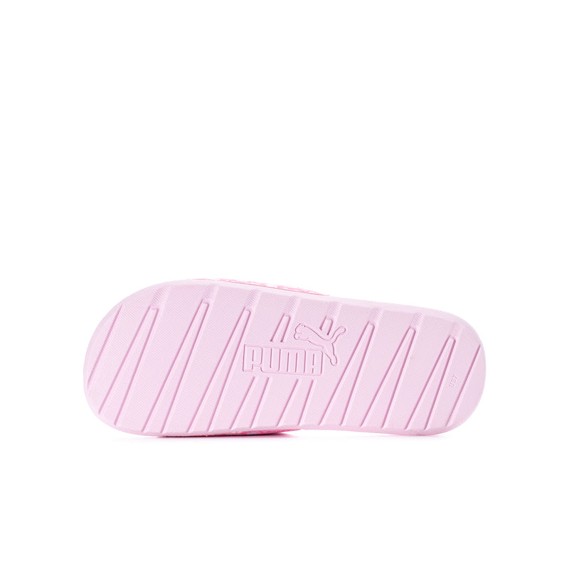 Youth slide sandals with pink rubber outsole, Puma logo, and tread grooves.
