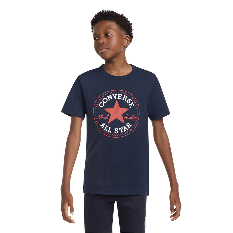 Youth navy graphic T-shirt with Converse All Star emblem, angled front view