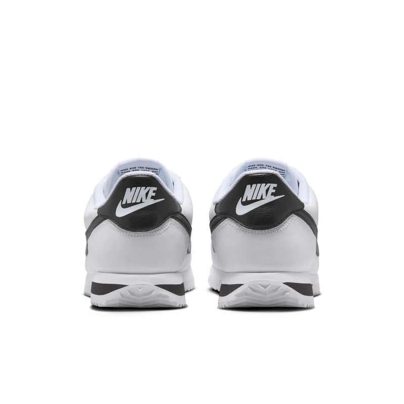 Women's white low-top sneakers with black heel accent and Nike logo on back