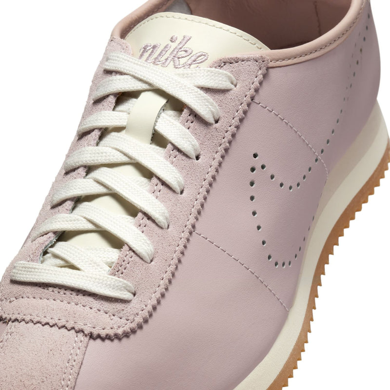 Women's Cortez sneakers close-up, particle rose upper with sail laces and stitching